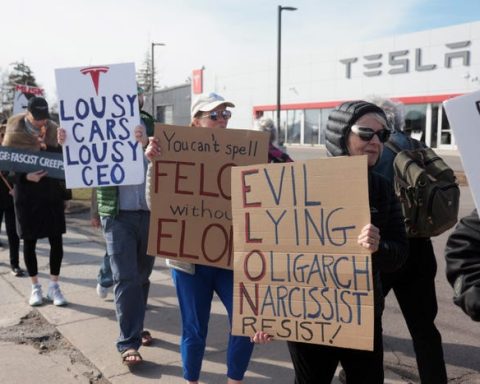 Protesters Rally Against Elon Musk Outside Tesla Dealership in Ann Arbor