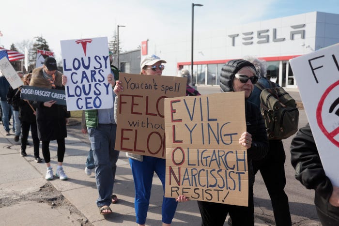 Protesters Rally Against Elon Musk Outside Tesla Dealership in Ann Arbor
